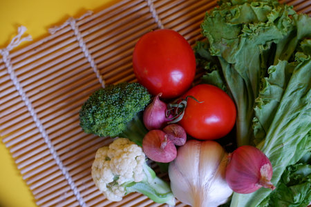 Vegetables in a basket on a wooden background. Selective focus.