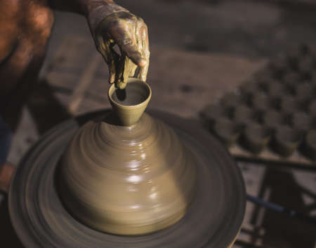 Unfinished Clay Diwali lamp with blurry  Pottery wheel. Selective Focus is used.