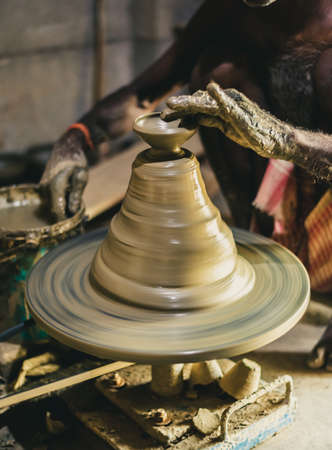 Unfinished Clay Diwali lamp with blurry  Pottery wheel. Selective Focus is used.の写真素材