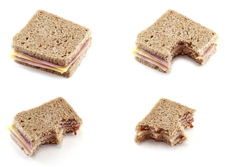 eating a sandwich of cheese and ham の写真素材