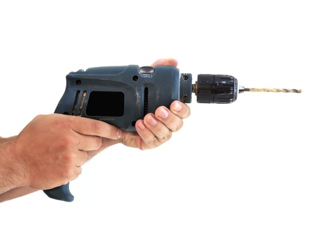 manÂ´s hands with a dirty electric drill