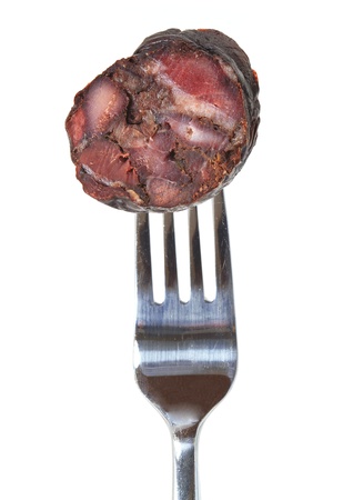 slice of portuguese spicy sausage in a forkの写真素材