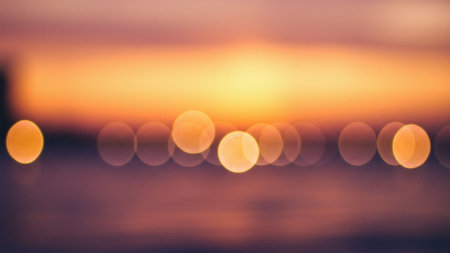 Warm Orange and Purple Sunset Bokeh Lightsの素材