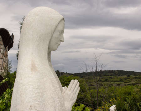 Statue of a woman prayingの写真素材