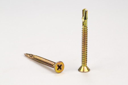 Metal bolts and screws on white backgroundの写真素材