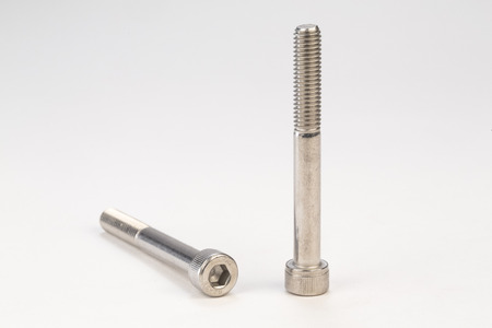 Metal bolts and screws on white backgroundの写真素材