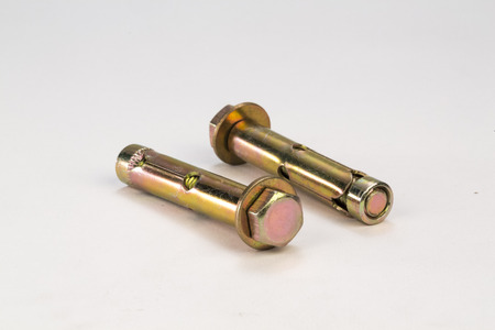 Metal bolts and screws on white background
