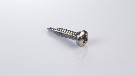 Metal bolts and screws on white background
