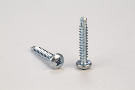 Metal bolts and screws on white backgroundの写真素材