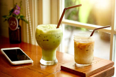 relaxing  relax time after work with ice green tea glass ice latte smart phone mobile phone wood...