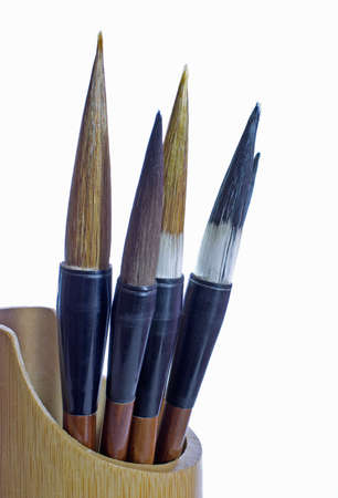 Paint brushes in wooden standの写真素材