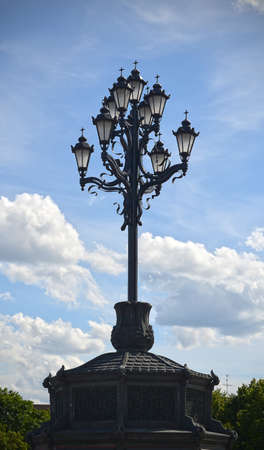 Decorative Church street lamp against the skyの写真素材