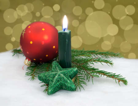 Burning candle, fir branch and Christmas decorations closeupの写真素材