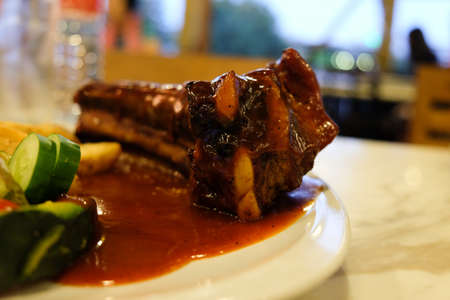 Pork rip barbecue steak serve with french fries and organic salad side dish