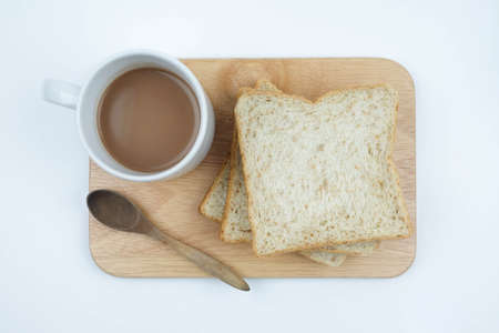 Sliced Whole wheat bread and a cup of coffee on Chopping Wood on white background, Healthy concept