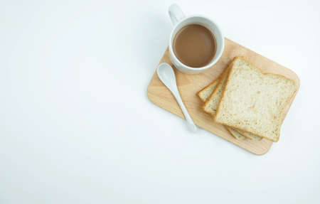 Sliced Whole wheat bread and a cup of coffee on Chopping Wood on white background, Healthy conceptの写真素材