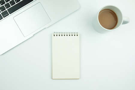 Creative flat lay design of workspace desk with laptop, notebook and coffeeの写真素材