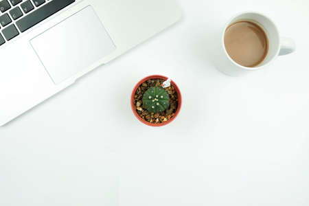 Creative flat lay design of workspace desk with laptop, cactus and coffeeの写真素材