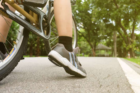 A woman prepare to riding a bicycle in the park in the eveningの写真素材