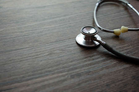 Stethoscope on wooden table background. medical health conceptの写真素材