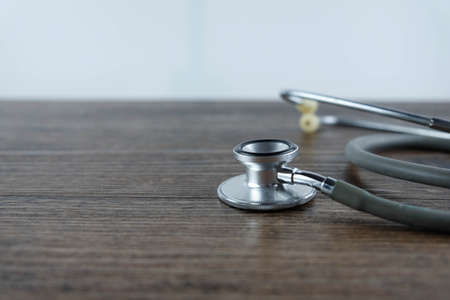 Stethoscope on wooden table background. medical health conceptの写真素材