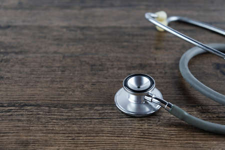 Stethoscope on wooden table background. medical health conceptの写真素材