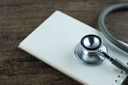 Close up of Stethoscope and blank notebook, Concept for Medical Education or health recording.