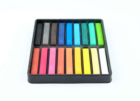 Set of colourful chalk pastel in a box on white backgroundの写真素材