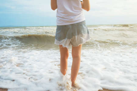 Women walking alone on the beach