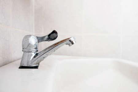 Close up faucet in the bathroom , save water concept