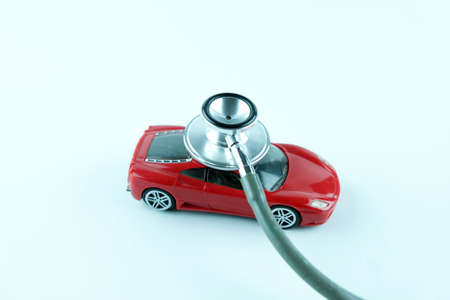 Stethoscope checking up the car on white background, Concept of car check up, repair and maintenance.の写真素材