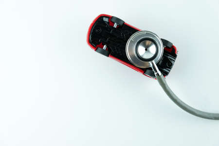Stethoscope checking up the car on white background, Concept of car check up, repair and maintenance.の写真素材