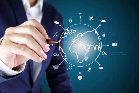 Businessman pointing a global with line icon of IOT.Internet of things technology concept.の写真素材