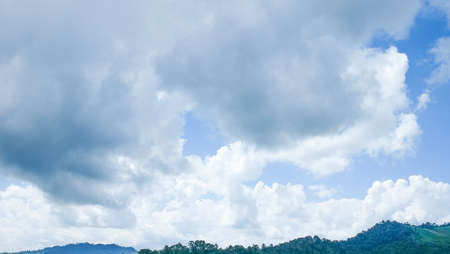 Blue sky in white clouds with mountainの写真素材