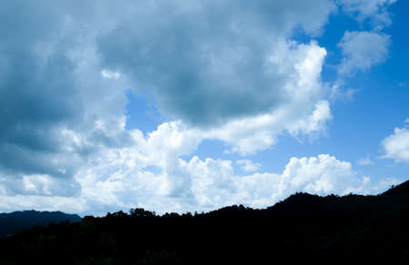 Blue sky in white clouds with mountainの写真素材