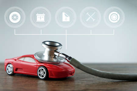 Stethoscope and car with service icons on the wooden background, Concept of car checking, repair and maintenance.の写真素材