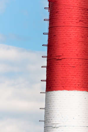 High red and white tube boiler against the blue skyの写真素材