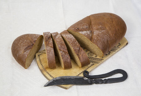 still life. food. sliced rye bread with a knife on a trayの写真素材