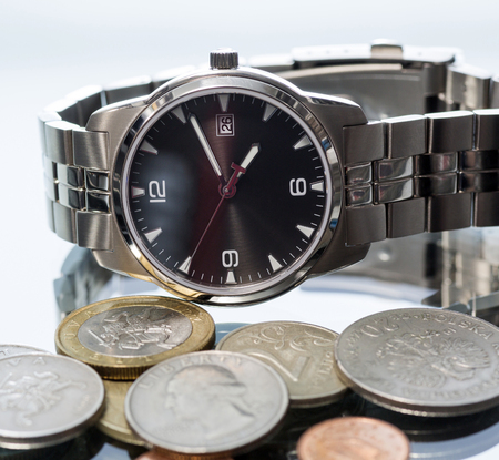 Men39s wrist watch and metal coins. reflection. closeup. Macro.の写真素材