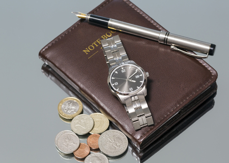 wrist watch metal coins pen. notebook. close-up. Macro.の写真素材