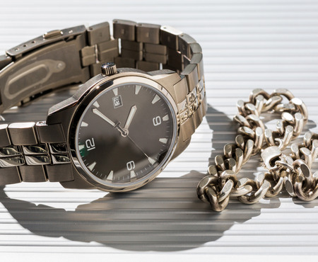 Watches and jewelry chain on a light background. Business still-lifeの写真素材