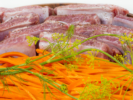fragment, raw meat and ribs sliced carrots on a tray. cooking delicacies. White background. isolated.の写真素材