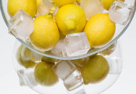 Fresh yellow lemon ice-cooling. dish, mirror reflection. fruitの写真素材