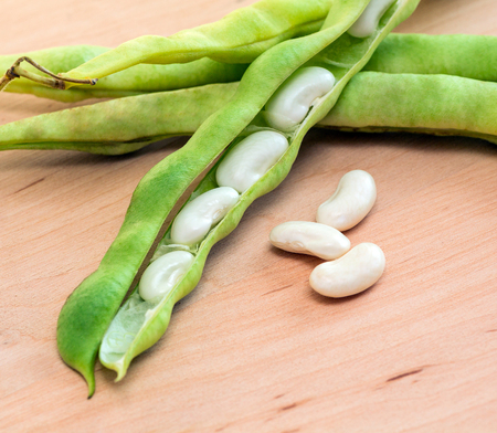 green pod white beans close-up on a wooden table. vegetables, cereals. macro.の写真素材