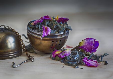 tea leaves and rose petals and cylinder filter for brewing teaの写真素材