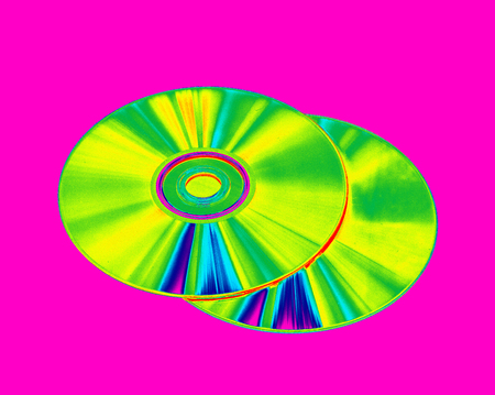 CD-ROMs and DVD-discs on a pink background, a color gradient imageの写真素材