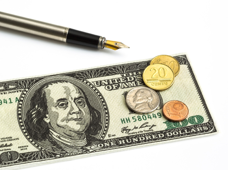 coins, currency notes; pens close-up on a white background, money, currency, businessの写真素材
