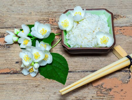 healthy power concept, Eco, a dish with jasmine rice and jasmine flowers on a wooden backgroundの写真素材