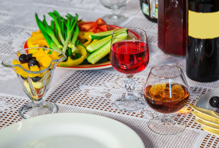 wine glass with wine fruit, vegetable on the table, elegant place settings, cutleryの写真素材