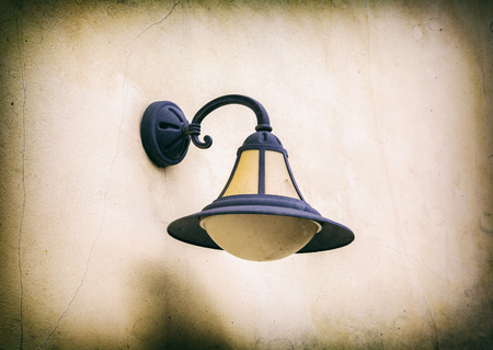old street lamp close-up of the old wall, retro styleの写真素材